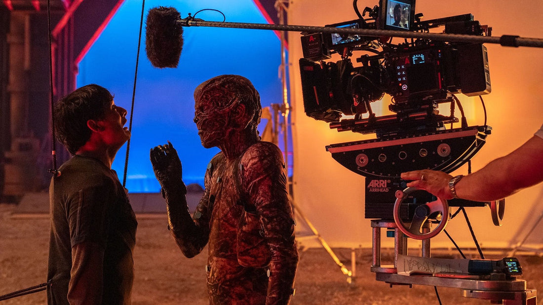 Stranger Things shoot: camera, boom mic and a blue screen facing an actor made up as a creature