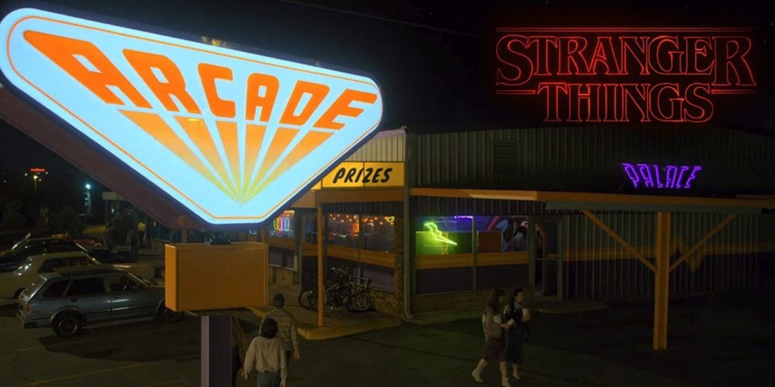 The Palace ARCADE neon sign lit at night in Stranger Things, figures outside the entrance