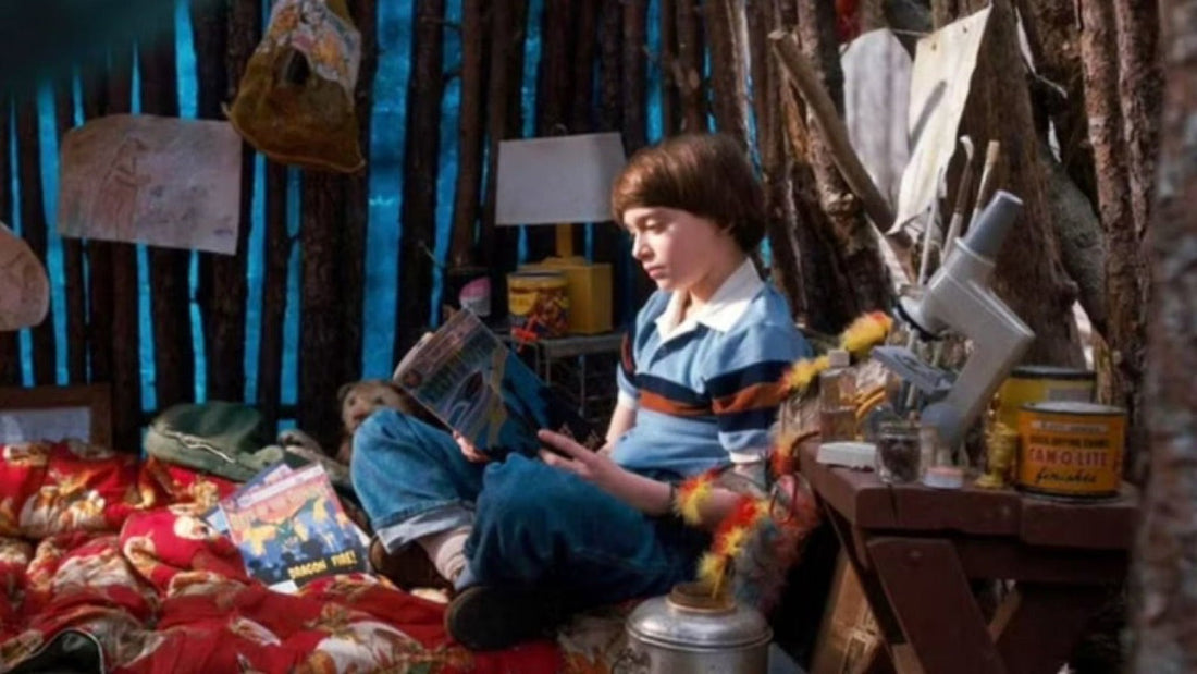 Will lying in a plank fort, under blankets, with drawings on the wall.