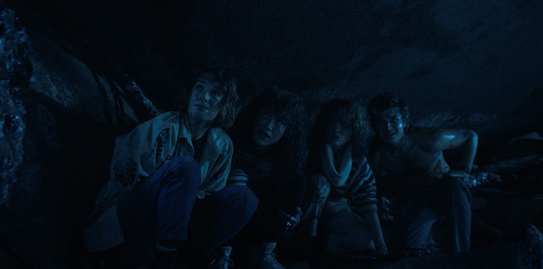 Nancy, Robin, Eddie and Steve, soaked, under the rock after the dive.