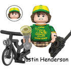 Buildable mini figure Stranger Things Dustin Camp Know Where on a bike